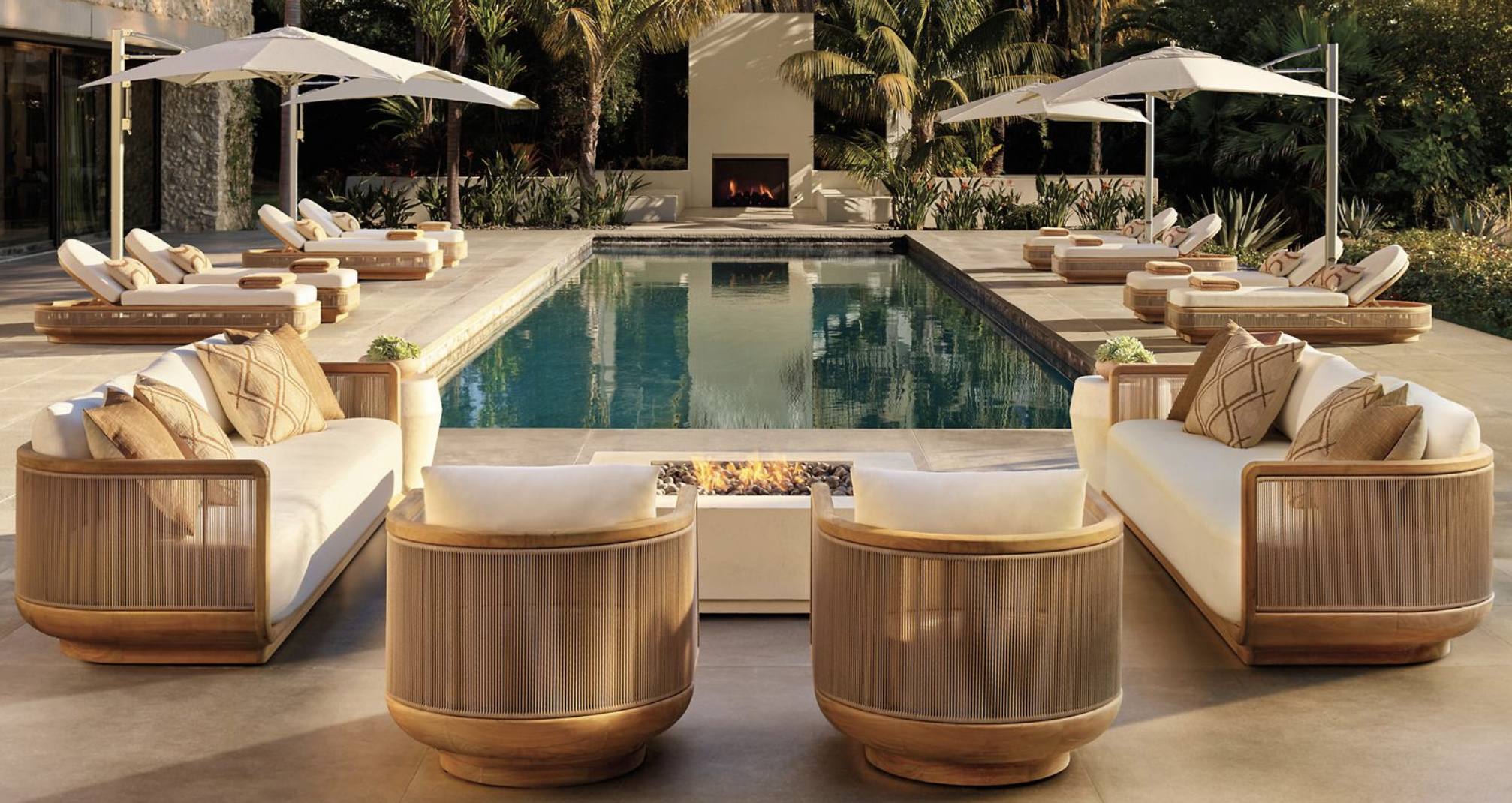 Lave bespoke outdoor teak and rope furniture around a poolside fire pit