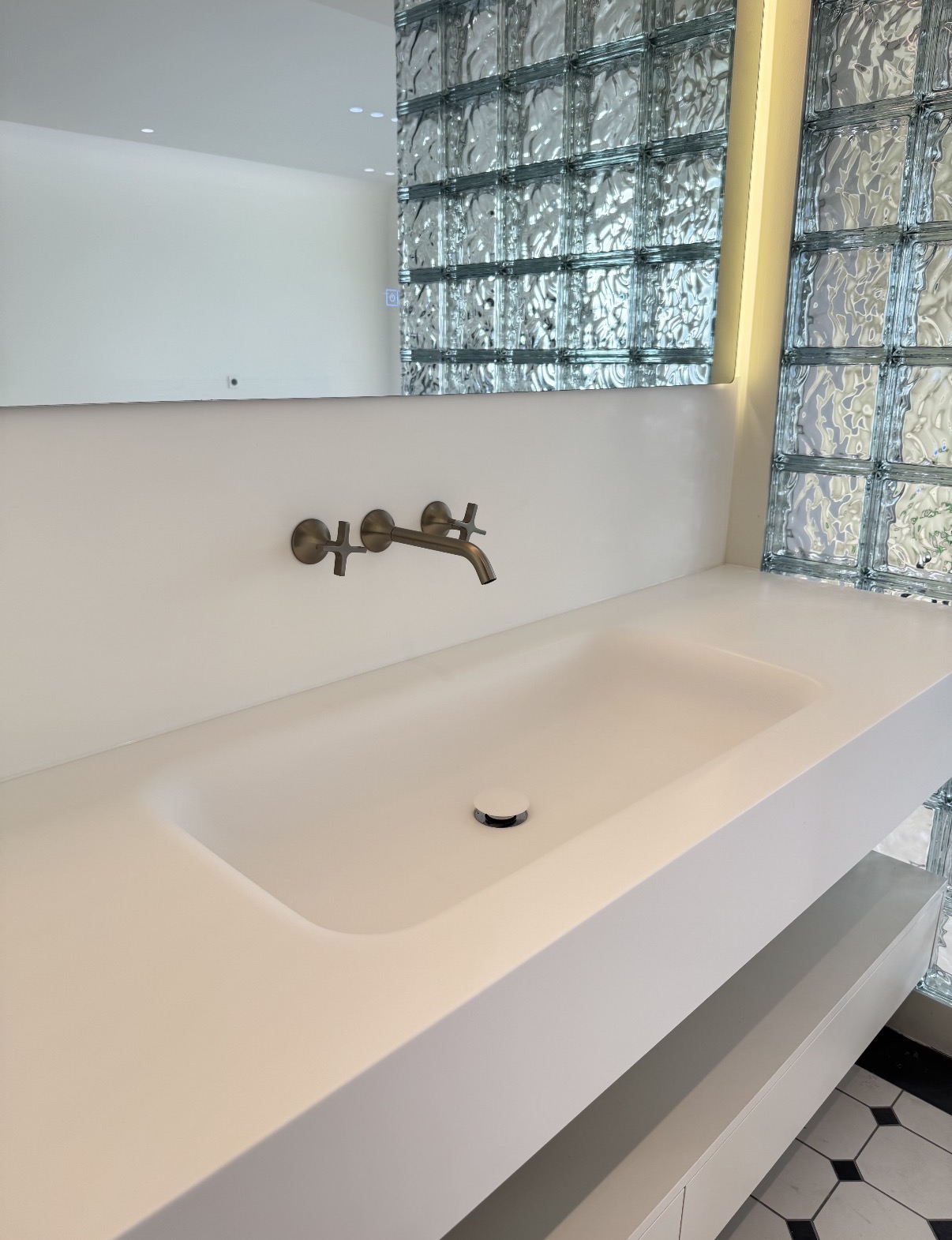 Lave 2000mm sintered stone basin with 20mm counter drop and warm oak vanity unit, installed in a contemporary London flat